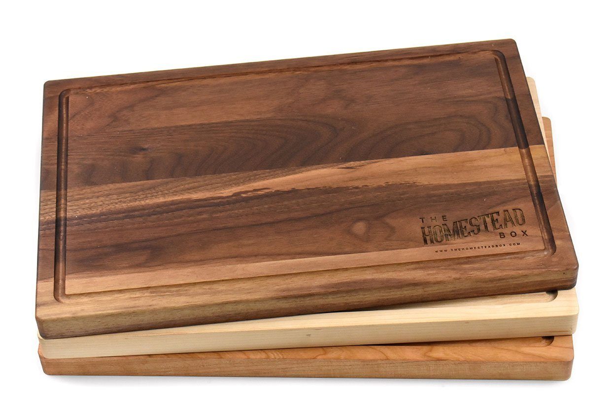 https://www.haileyhome.com/cdn/shop/products/personalized-walnut-cutting-board-with-rounded-edges-and-juice-groove-11-x-17-bulk-discounts-709343_1024x1024@2x.jpg?v=1628786966